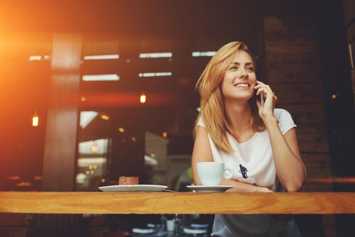 A woman happily talking on the phone.