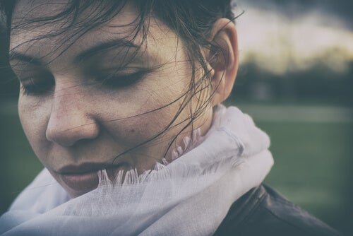 A woman standing outside in the wind.
