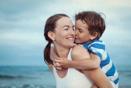 A mother with her son on the beach.