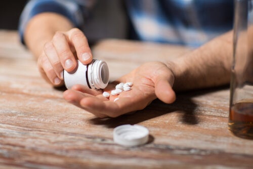 A person emptying some antidepressants into their hand. 