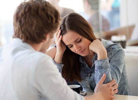 A couple talking in a cafe.