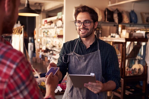 An employee talking to a customer at a store.
