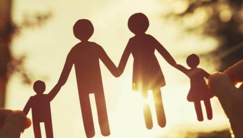 A family-shaped paper in a sunset.