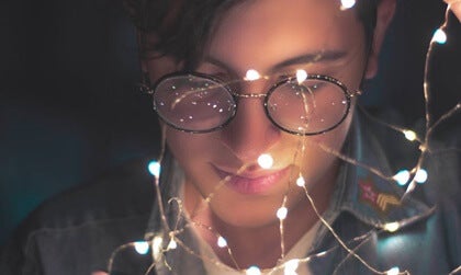 A girl surrounded by lights.