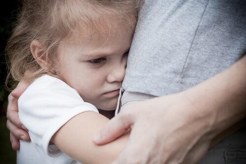 A girl hugging her mother tightly.