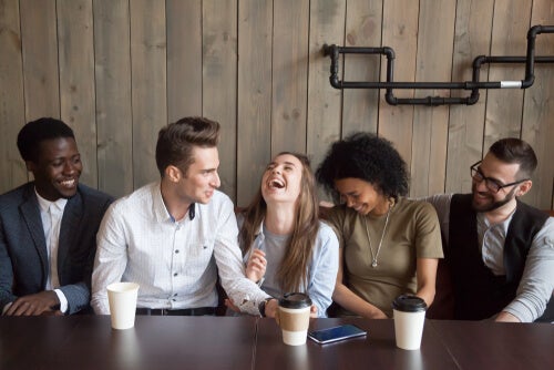 A group of friends and loyal people laughing together at a table.