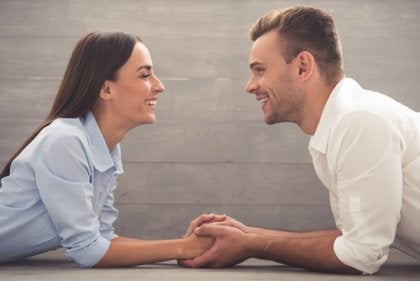 A happy couple holding hands.