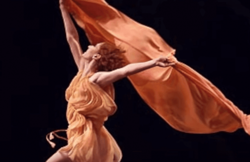 A woman dancing with a scarf.
