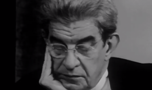 Jacques Lacan thinking with glasses on.