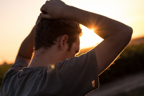 A man looking at a sunset.