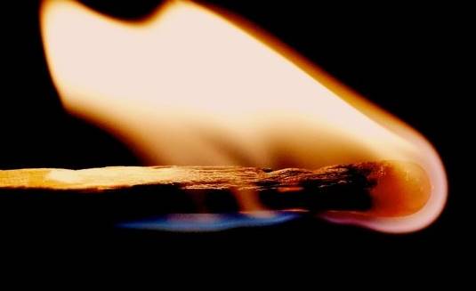 A lit match burning out.