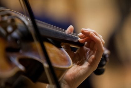 The hand of a violinist playing.