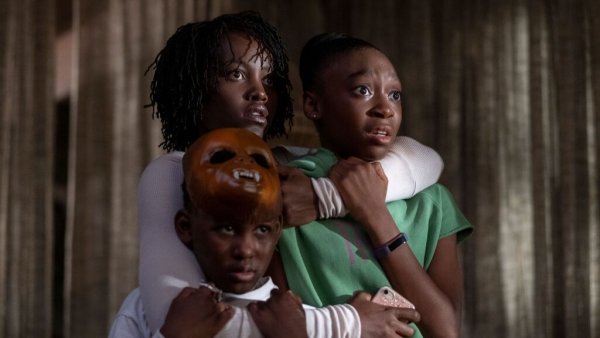 The mother in Us standing with her two kids in her arms, protecting them. 