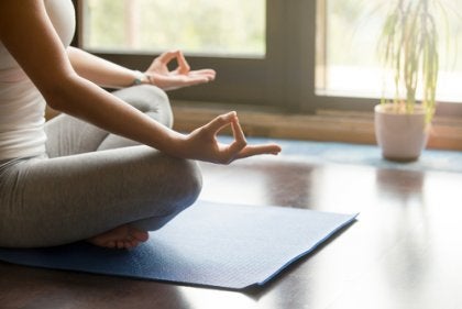 A woman meditating at home.