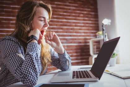 Yawning cools the brain of a woman working on her computer.
