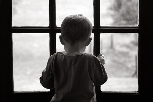 A little child looking out the door.
