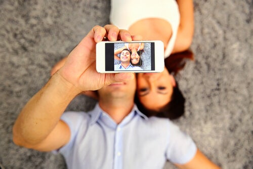A man taking a selfie of himself and a woman.