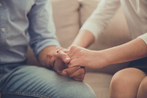 A woman and a man holding hands.