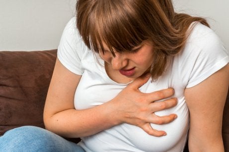 A woman holding her chest.