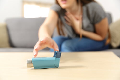 A woman reaching for the inhaler.