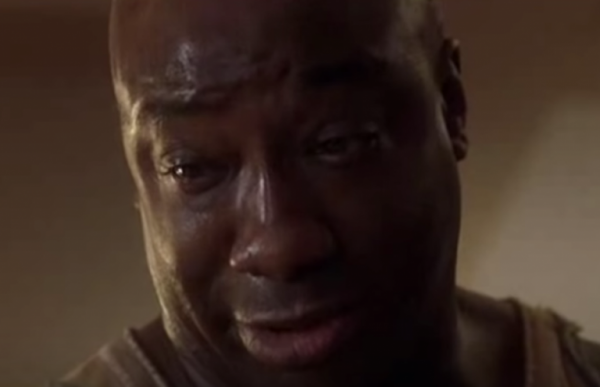 John Coffey in The Green Mile looking down, with tears in his eyes.
