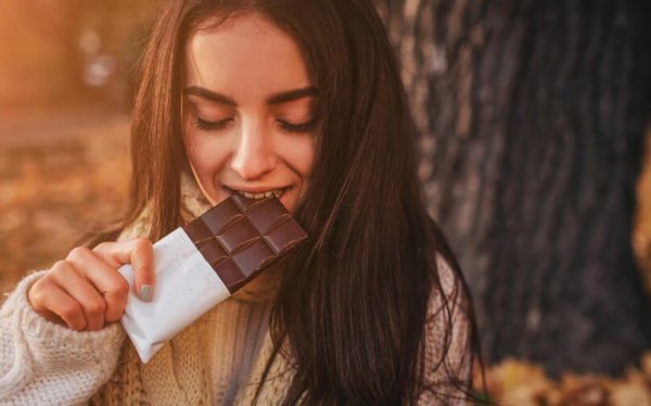 A woman eating chocolate.