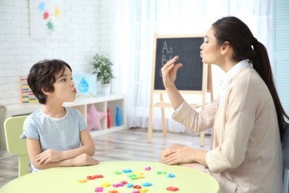 A speech therapist working with a child.