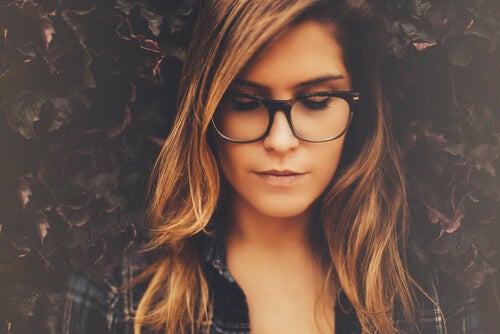 Woman with her eyes closed wearing glasses.