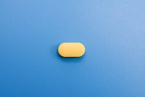 A small pill lying on a table. 