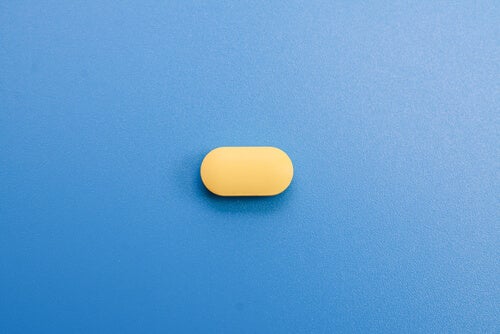 A small pill lying on a table.