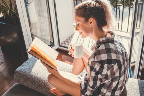 A woman reading by the door.