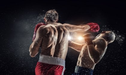 A boxer getting hit in the head.