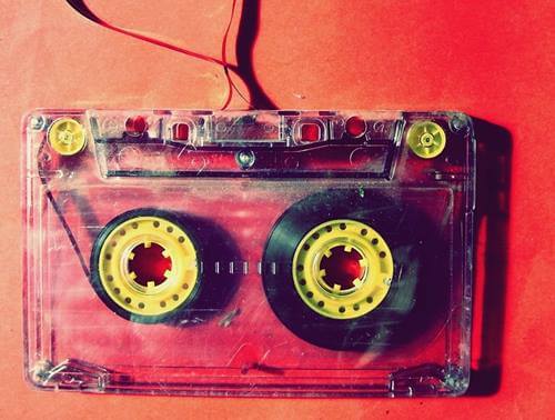 A cassette on a red background.