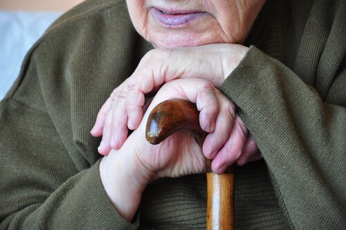 An elderly person using a cane.