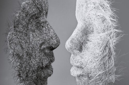 Two silhouettes of faces looking at each other close-up. 