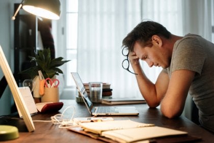 A guy with work-related fatigue at his desk.