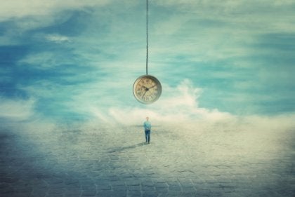 A man standing under a giant clock.