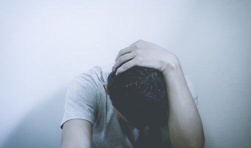 A man worried with his head down.