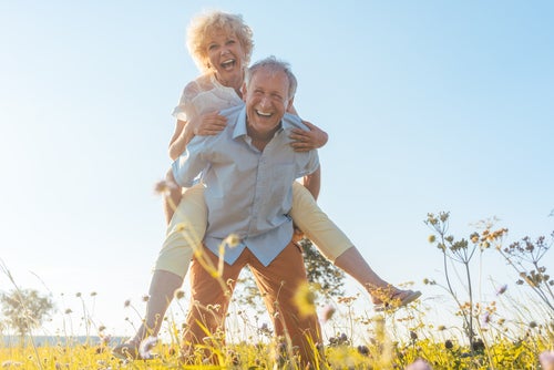 An older couple having fun outside.