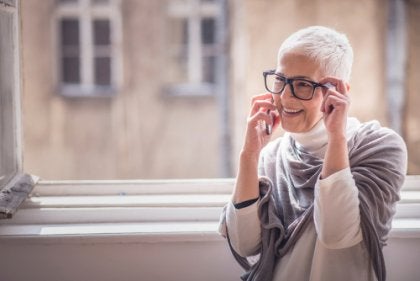 An older woman talking on the phone.