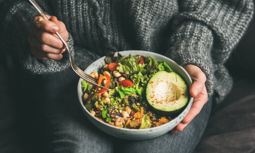 A person eating vegetables.