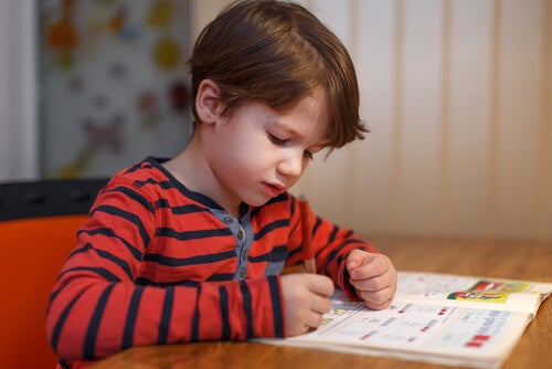 A child writing on a book.