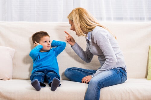 A mother scolding her child, representing behavior modification in children.