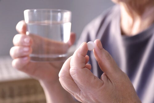 A woman taking a pill.