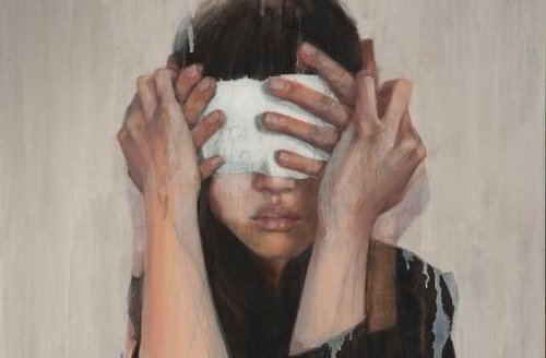 Someone putting a blindfold on a woman.