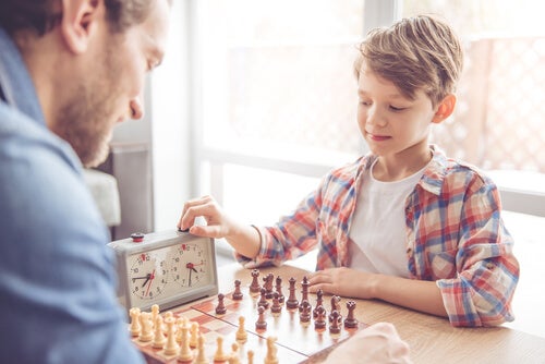 A man and a boy playing chess.