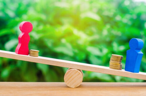 The gender gap: figures of a man and a woman on a balance of money.