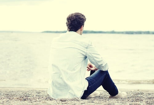 A man sitting by the shore.