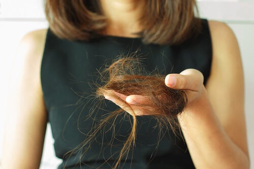 A woman experiencing hair loss.