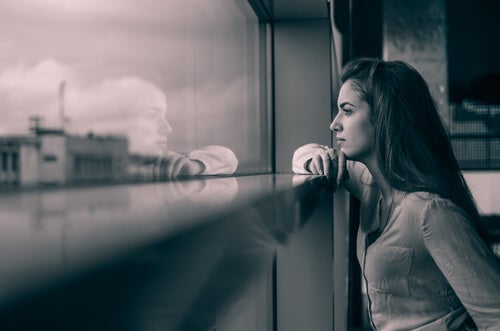A woman looking out of a window.